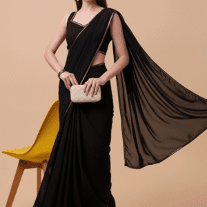 Elegant black chiffon saree with gold border draped on a mannequin.