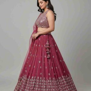 Model posing in a wine pink mirror work lehenga for a wedding reception