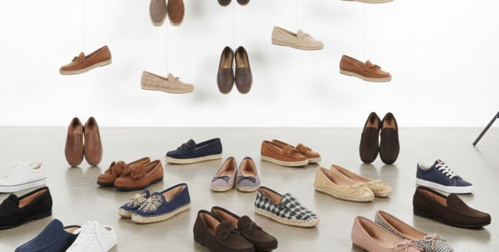 A pair of classic ballet flats on a wooden floor.